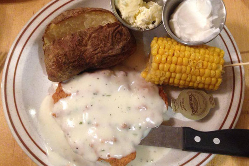 Country Fried steak dinner with corn and mashed potatoes