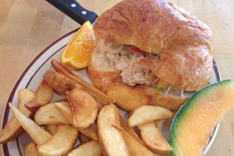 Le Tuna Croissant Sandwich with fries and melon
